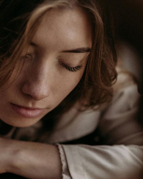 Woman with closed eyes in a state of calm meditation.